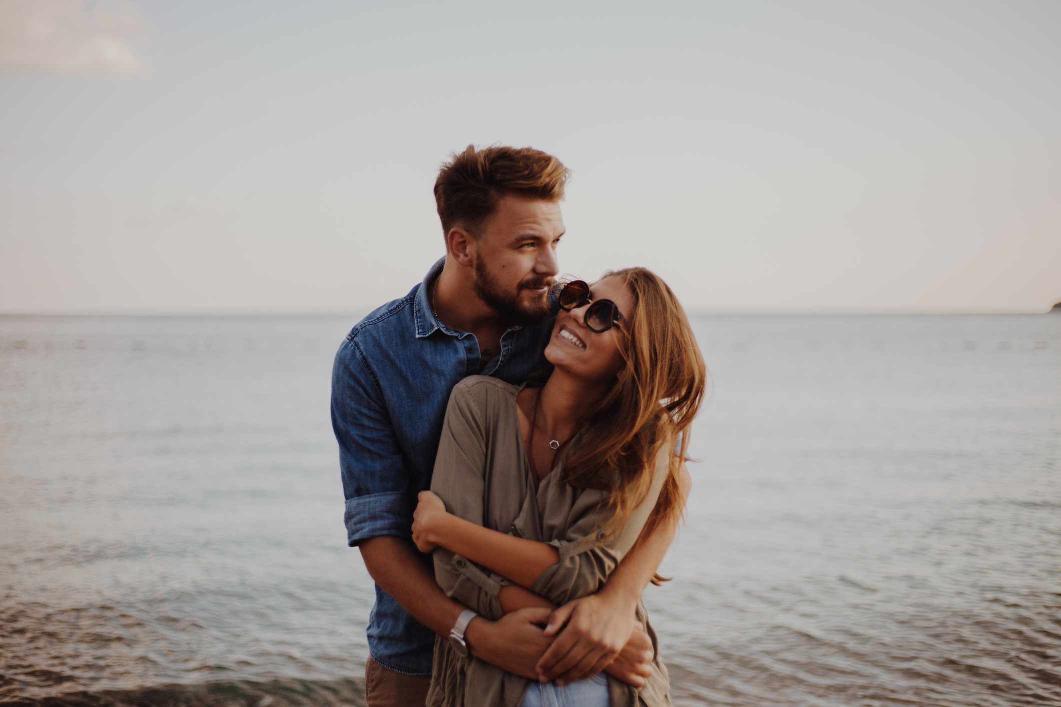 Couple embracing at the beach representing sexual health, intimacy, confidence, and wellness support at LeHeal Biogenix.