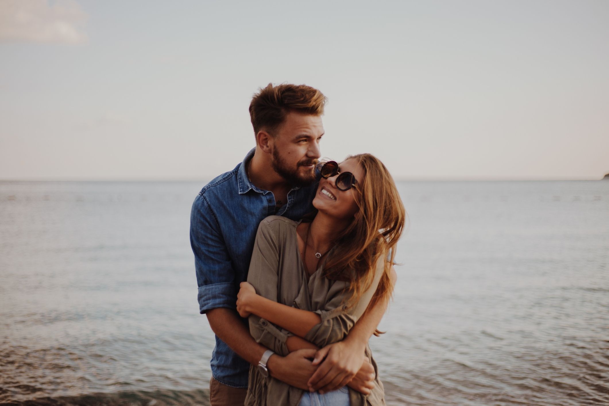 Couple embracing at the beach representing sexual health, intimacy, confidence, and wellness support at LeHeal Biogenix.